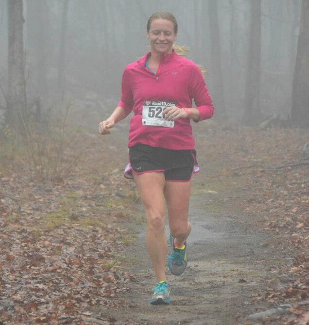 Runner competing on a foggy forest trail during the Arkansas Trail Run Series at Lake DeGray.